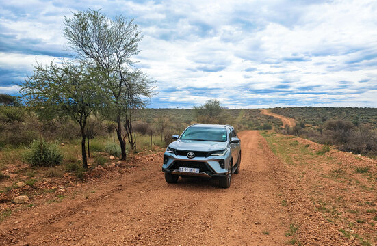 Off-road driving a rental car on a gravel road, a 4x4 track in a sandy desert landscape in Namibia. Toyota Fortuner SUV 4x4 off-road vehicle.
March 8, 2025.  Kalahari, Namibia Africa.