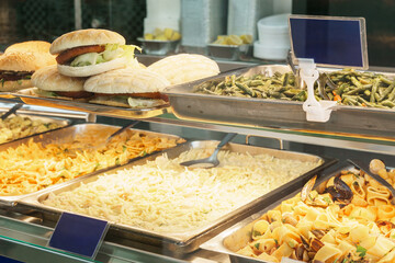 Display case offering sandwiches, pasta, and vegetables in Sicily, Italy