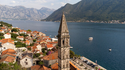Aerial view of bell tower in Perast city in Kotor Bay, Montenegro. Cityscape of the country tourist attraction in summer travel