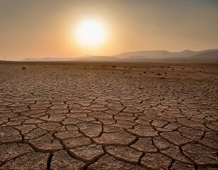 wide panorama of desolate cracked terrain with the sun faintly visible through the dust storm drought and desertification concept