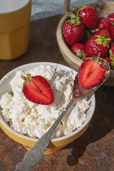 Fresh strawberry curd cheese, served in a yellow bowl along with a bowl of fresh strawberries. Healthy Breakfast