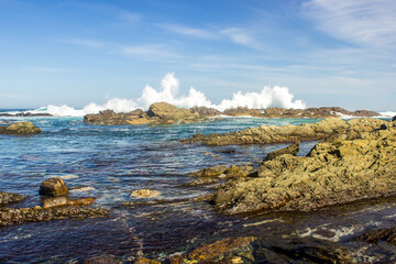 Waves breaking spectacular on the rocky coastline of the Tsitsikamma section of the Garden Route National Park, South Africa.