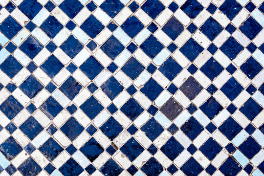 Traditional Moroccan blue and white zellige diamond tile pattern from Marrakesh, featuring geometric mosaic design, historic artisan craftsmanship, ornamental decoration or authentic cultural heritage