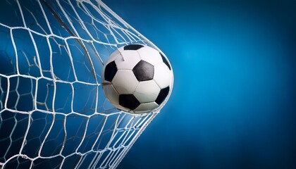 soccer ball in goal net on blue background