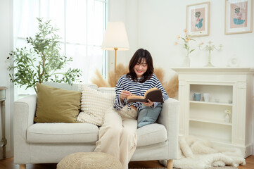 Young Woman Enjoys Reading a Book in a Cozy Living Room Setting