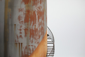 Artistic image of rusted staircase on old fuel tank at Port Nolloth harbour, South Africa