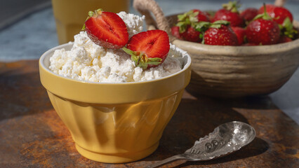 Fresh strawberry curd cheese, served in a yellow bowl along with a bowl of fresh strawberries. Healthy Breakfast.