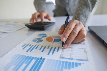 Close up accountant banker or bookkeeper making calculations with calculator.