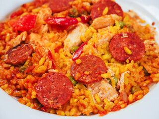 Close up of fine tasty Spanish paella dinner with rice and high quality chorizo sausage. Mediterranean style dish. Popular food made from premium ingredients.