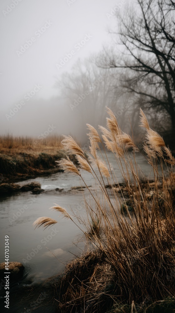 Aufkleber serene riverbank scene with tall grass in foreground and misty background creating a tranquil atmosp