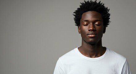 Obraz premium Man Meditating with Eyes Closed for Calmness and Inner Peace