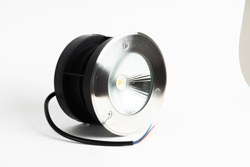 Compact Round LED Spotlight with Exposed Wires Isolated on White Background

