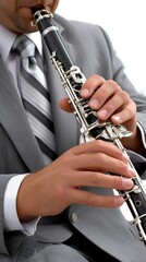 Fototapeta premium Close-up of hands skillfully playing the clarinet in a grey suit on a white background focusing on musical performance and artistry