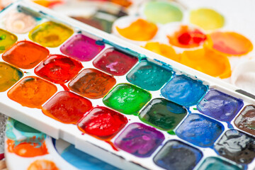 Watercolor paint in old used plastic palettes, creative mess