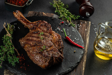 Barbecue Tomahawk Steak on a dark background. top view. copy space for text
