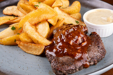succulent beef mignon dish with bbq wine sauce and rustic potatoes in macro close-up