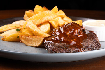 succulent beef mignon dish with bbq wine sauce and rustic potatoes close up