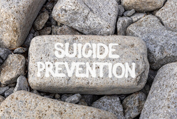 Suicide prevention symbol. Concept words Suicide prevention on beautiful big grey stone. Beautiful grey stones background. Psychological and suicide prevention concept. Copy space.