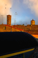 Ravenna, Italy landmark architecture rooftop aerial view with tile roofs and stone towers glowing...