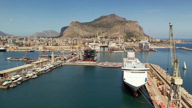 A ship sets sail on a tourist voyage. The majestic cruise ship GNV slowly sets sail from the port of Palermo, Sicily,  26.04.2025. The ship glides past the docks and out to sea.