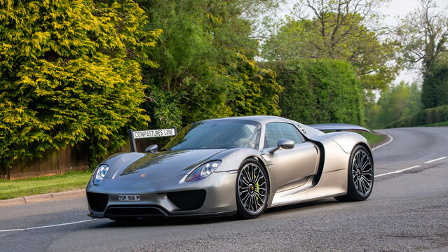 Whittlebury,Northants.,.UK - April 27th 2025:   2015 Porsche 918 Spyder hybrid electric car driving on an English country road.