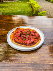 A vibrant plate of fresh salsa served outdoors, showcasing a colorful blend of ingredients ideal for summer meals.