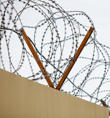 A fence with barbed wire on top of it