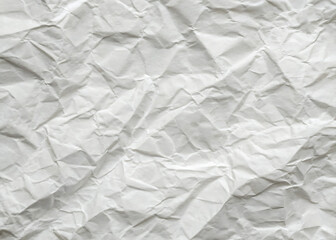 Fototapeta premium Crumpled white paper texture on a clean, blank surface, featuring wrinkles against a white background.