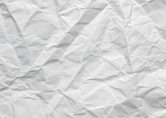 Obraz premium Crumpled white paper texture on a clean, blank surface, featuring wrinkles against a white background.