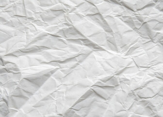 Naklejka premium Crumpled white paper texture on a clean, blank surface, featuring wrinkles against a white background.