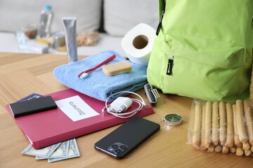 Survival kit. Different emergency supplies on wooden table indoors, closeup