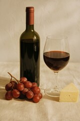 Elegant Pairing of Red Wine, Grapes, and Cheese on a Beige Tablecloth