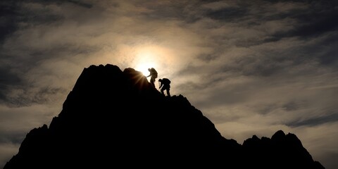 Hikers summiting a mountain at sunrise