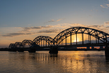 Railway Bridge over Daugava river in Riga, Latvia at sunset