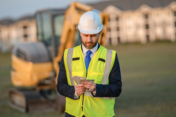 Businessman count money at site. Businessman invest money in construction business. Successful...