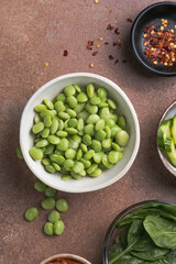 Vegan poke bowl ingredients with beans, spinach, cucumber, carrots and mangoes. Vegan food concept.