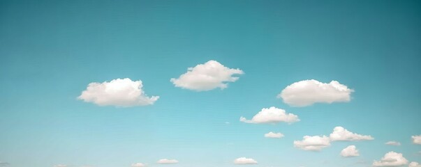 A serene expanse of sky dotted with fluffy clouds.