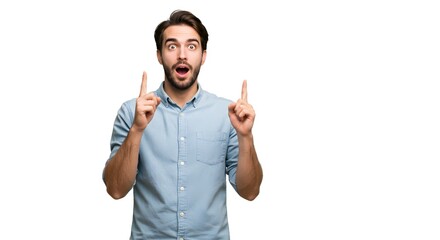 Fototapeta premium Surprised man in blue shirt pointing upwards with both hands against a plain white background showing shock
