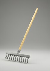 Elevated view of a pristine garden rake featuring wooden handle and grey metal head, showcasing simple tools on a neutral background