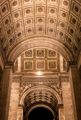 Architectural details of the ornate ceiling at the Arc de Triomphe in Paris during nighttime
