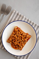 Homemade English Beans on Toast, top view. Overhead, from above, flat lay.