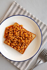 Homemade English Beans on Toast, top view. Overhead, from above, flat lay.