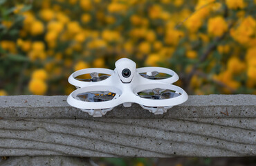 White FPV drone, tiny whoop in the nature 