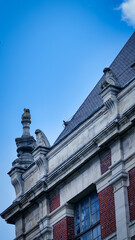 Close-up of the gable and the brick facade of a Parisian building