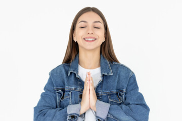 Portrait of young woman holds hands together, namaste gesture, say thank you, grateful, express...