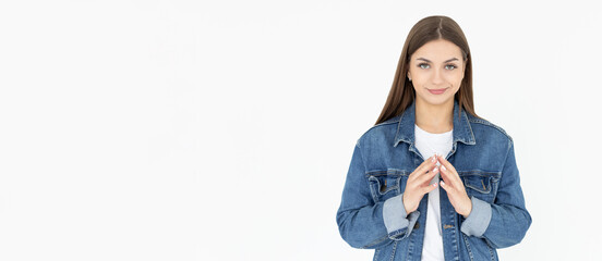 I have great evil plan. Confident and tricky woman in white t-shirt and jeans coat, holding fingers...