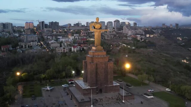Yerevan, Armenia &ndash; April 16, 2025: Aerial night view of the Mother Armenia statue illuminated in Victory Park against the backdrop of the city lights.