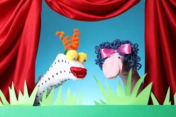 Creative puppet show on stage with decorations and red curtains
