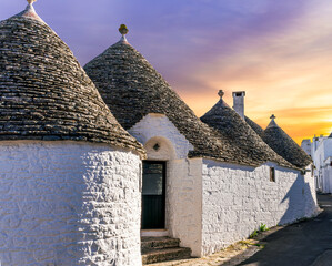 beautiful touristic view of white mediterranean buildings in old medieval Italian style of trulli...