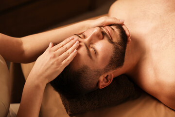 Fototapeta premium Man receiving relaxing massage in spa salon